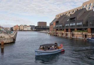 Guests on the Hygge enjoying a scenic canal tour in Copenhagen’s harbor