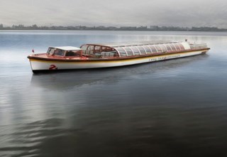 Stromma's white canal boat with a curved glass roof sailing in Copenhagen
