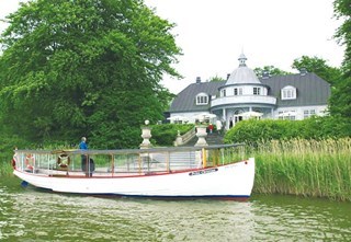 Baadfarten's boat 'Prins Christian' is docked in front of Aldershvile.