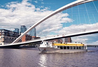 M/s Sofia sailing beneath the white Isoisänsilta Bridge in Kalasatama, Helsinki.