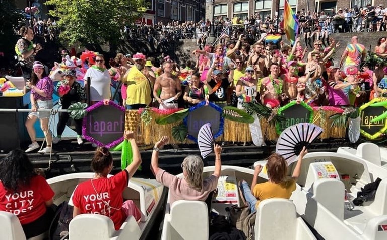 A group of spectators cheering on parade participants