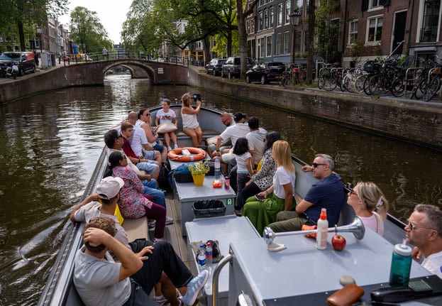 A medium sized sloop at the sailing through Amsterdam's canals