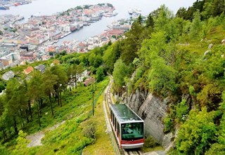Fløibanen funicular descending toward Bergen city center with view over the town.