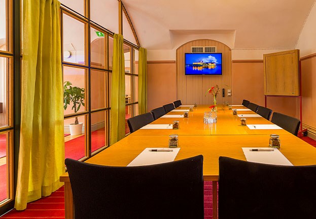 Conference room at Vaxholms Kastell - boardroom setup with notepads and pens