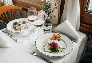 Dinner dishes presented on a table set with a white tablecloth