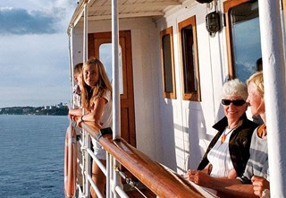  Boat passengers sitting on deck in the sun