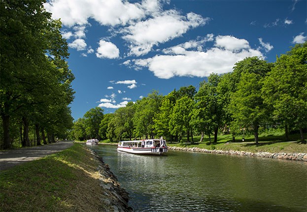 Sightseeing boat in the canal of Royal Djurgården in Stockholm