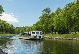 Sightseeing boat in the canal of Royal Djurgården in Stockholm